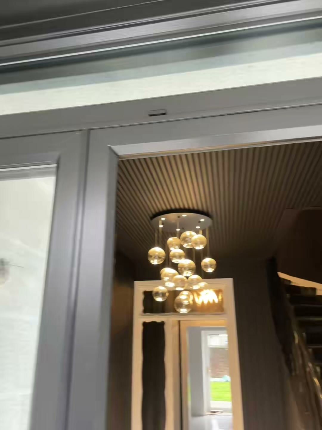 Inside the Virtu-Ali door: fanlight and side screen, pendant lights