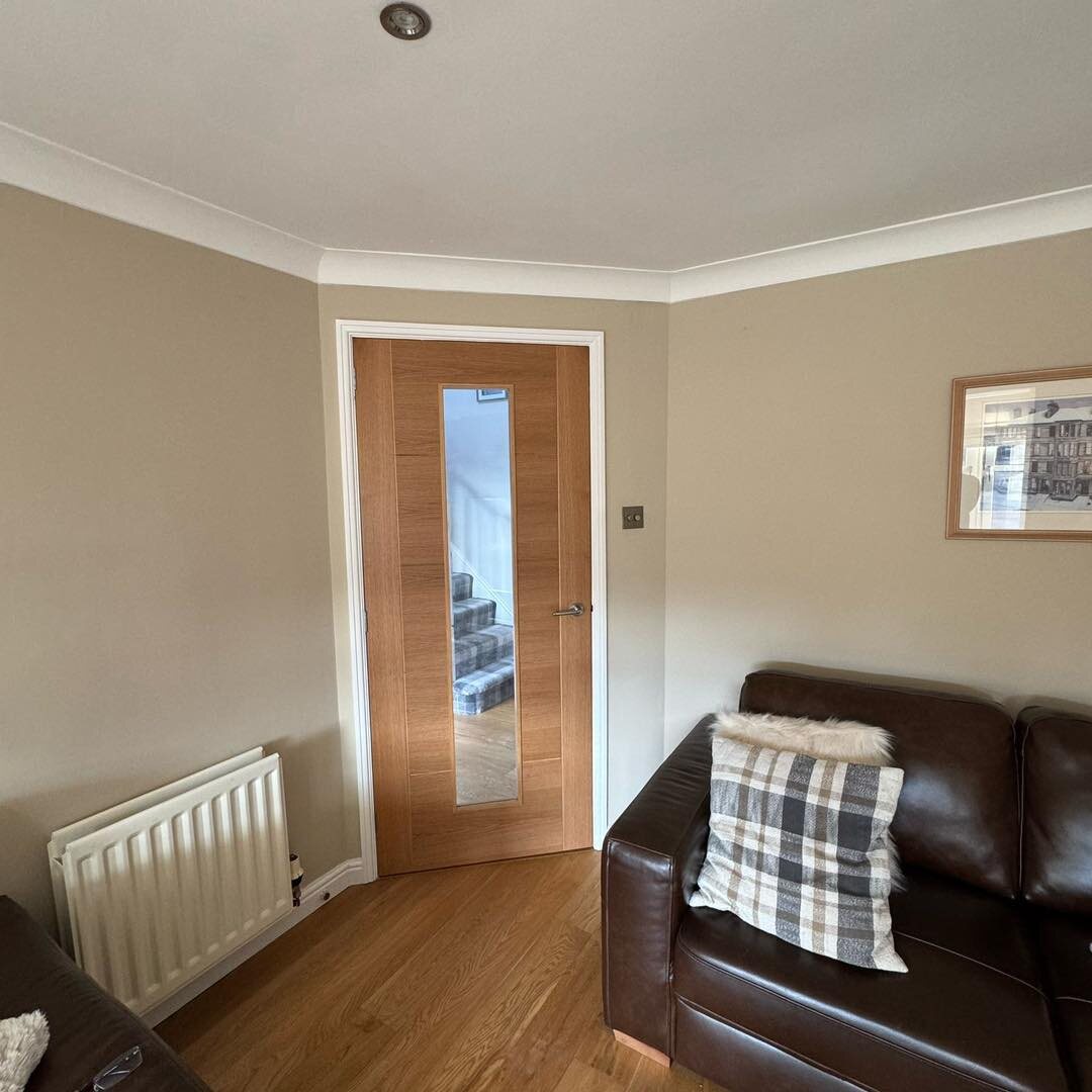 An oak internal door with a glazed panel, off a living room