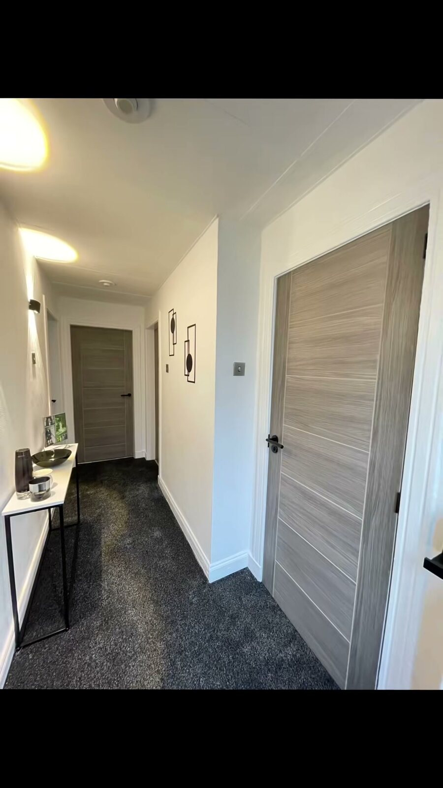 White-grey Palermo doors in a hall with grey carpet