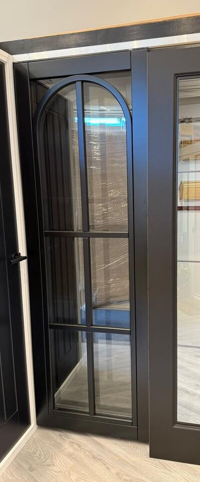 Black arched and urban glazed internal doors on the showroom display rack
