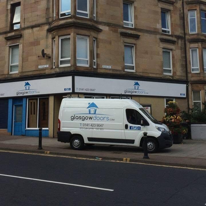 The Glasgow Doors shopfront on Cathcart Road, with the logo on the fascia and the van at the kerb