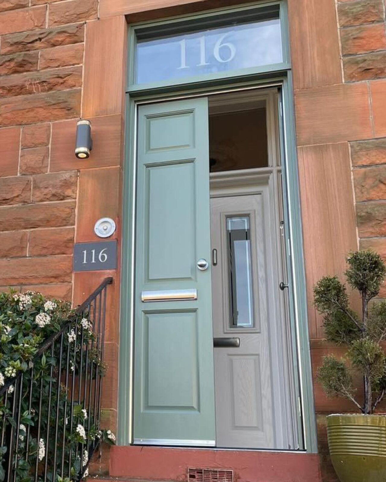 Handmade hardwood storm doors folded back to show the inner door