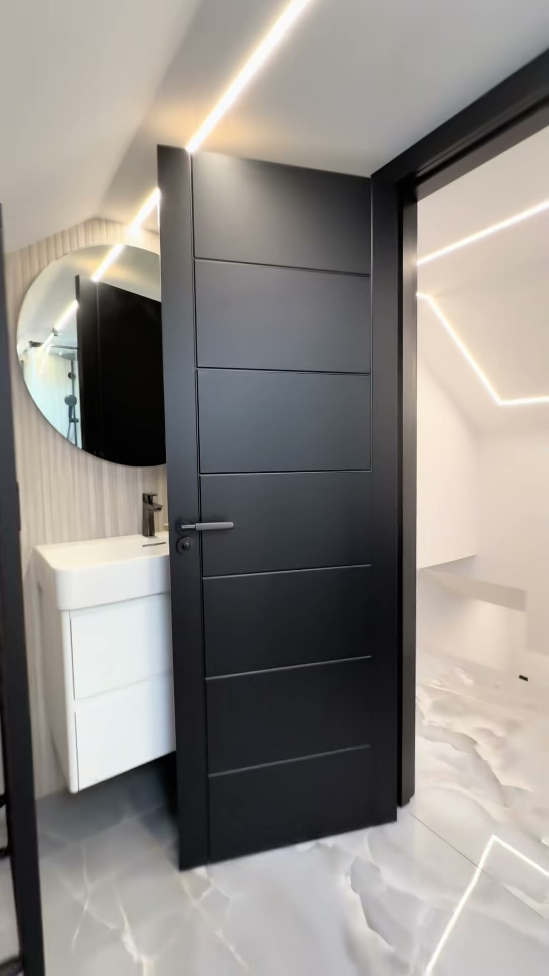 Still from our clip of a black door open onto a bathroom
