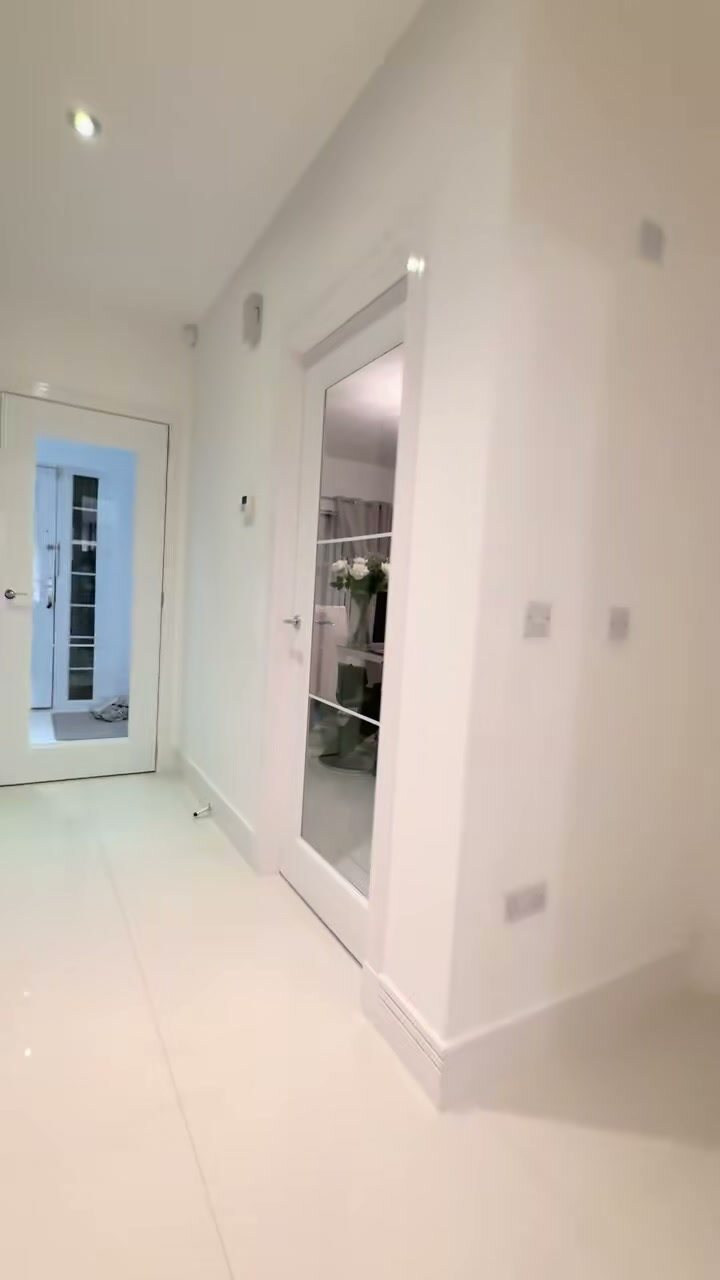 White urban glazed doors in an all-white hall